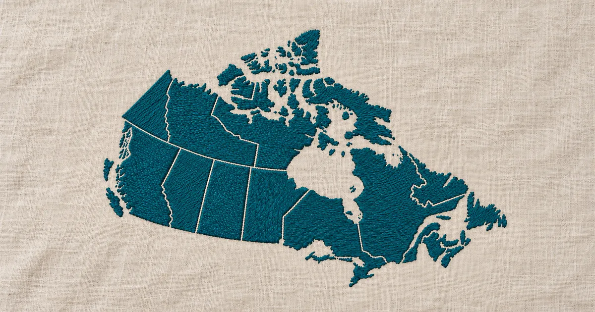 Embroidered map of Canada with provincial borders in teal thread on linen