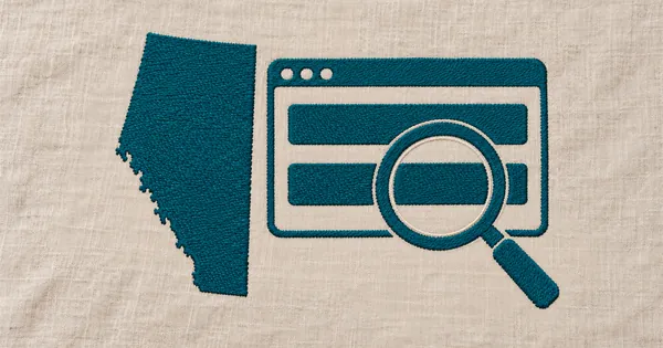 Embroidered outline of Alberta, a register window and a large magnifying glass